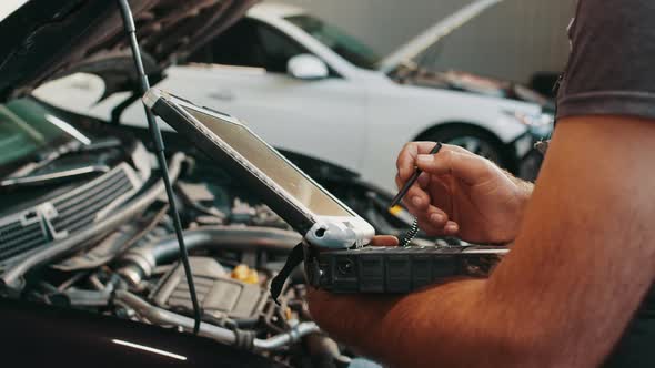 Hands of Mechanic Working in Auto Repair Shop