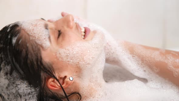 Close Up Relaxed Woman Touching Skin with Foam in Bath