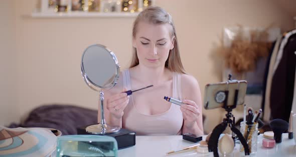 Woman Doing Makeup Painting Eyelashes with Mascara