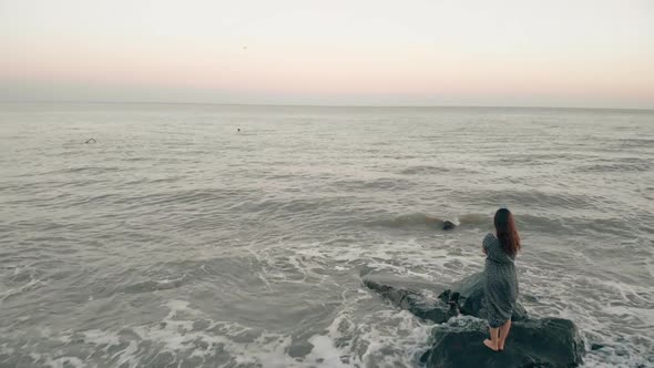 Alone Woman Look with Hope at the Ocean