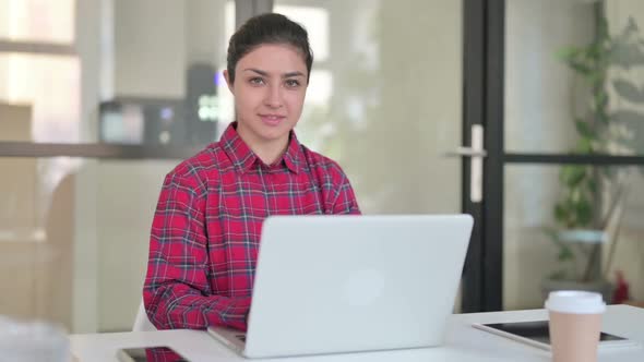 Thumbs Up By Indian Woman with Laptop at Work