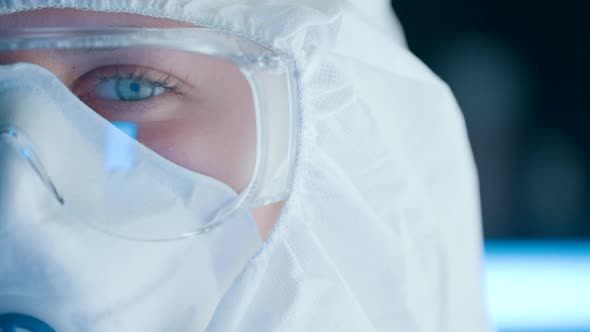 Portrait of a Doctor Virologist or Scientist in Medical Uniform is Looking at Camera at Biohazard