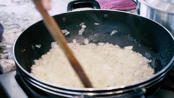 Frying diced onions in frying pan