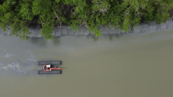 Top down view amphibious excavator move at river