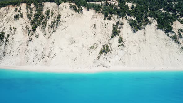 Drone view of scenic beach with white sand and turquoise sea, Greek islands.