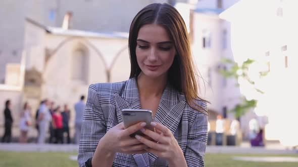 Woman With Phone. Beautiful Girl Using Smartphone Outdoors