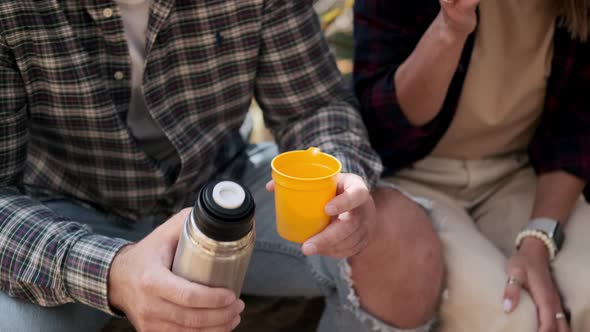 Halt in Hiking Man and Woman are Drinking Tea From Thermos Flask