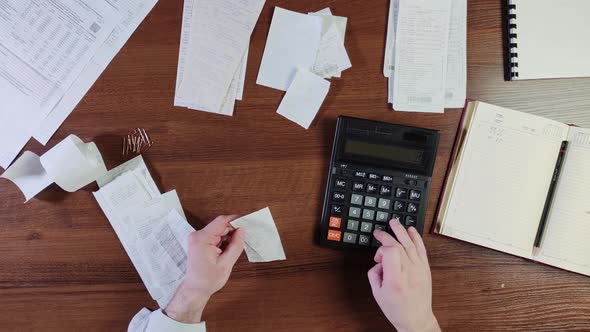 Home Budget. Man Reviewing Receipts