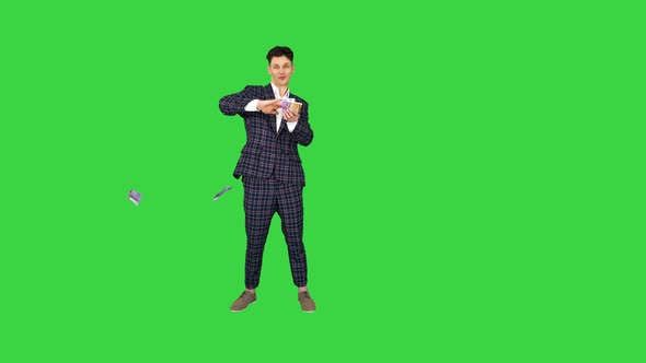 Wealthy Businessman Throwing Money in Air on a Green Screen, Chroma Key.