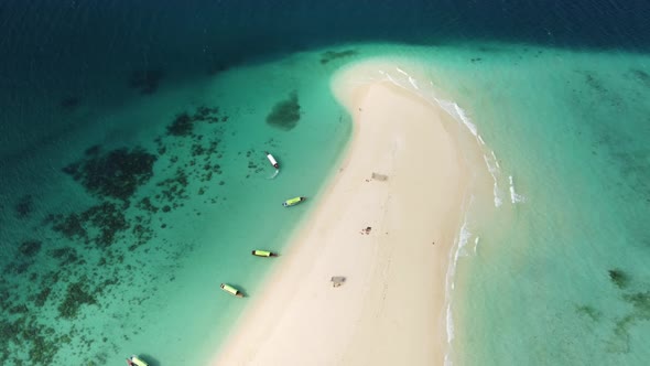 Aerial cinematic drone shot of an amazing, heavenly, paradisiacal deserted island with traditional b