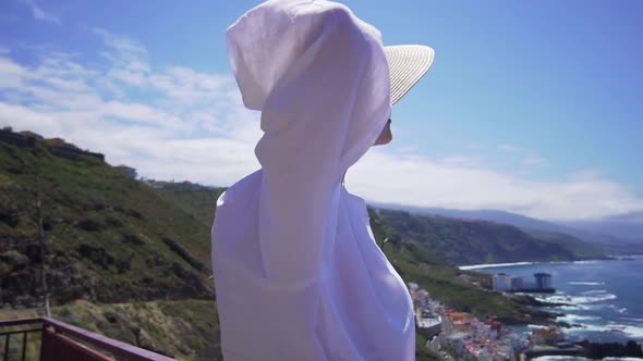 Beautiful Girl Model in a Hat on a Sunny Summer Day Near the Ocean. Portrait of a Caucasian Woman on