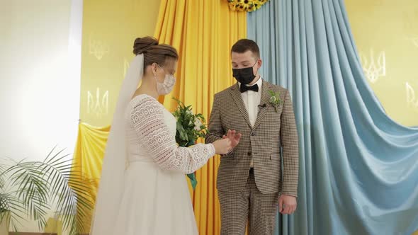 Newlyweds. Caucasian Groom with Bride Exchanging Rings on Wedding Ceremony. Coronavirus Covid-19