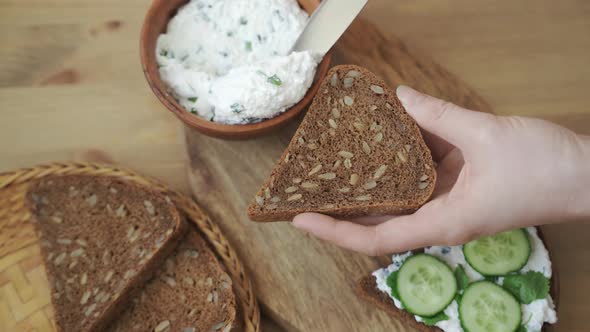 Spreading Curd Cheese on a Piece of Bread