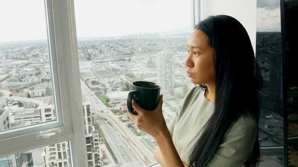 Woman having coffee at home 4k