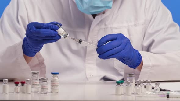 Medical Worker in Protective Gloves Draws Vaccine Samples Into a Syringe and Writes a Journal Entry