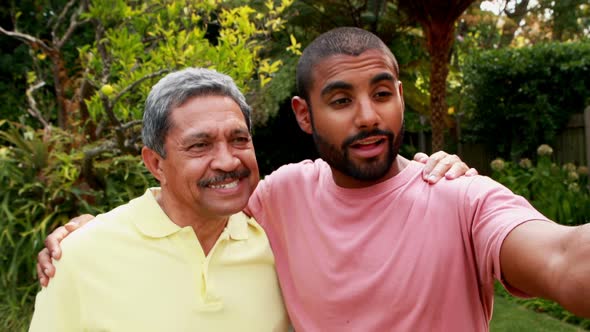 Father and son taking selfie with mobile phone 4k