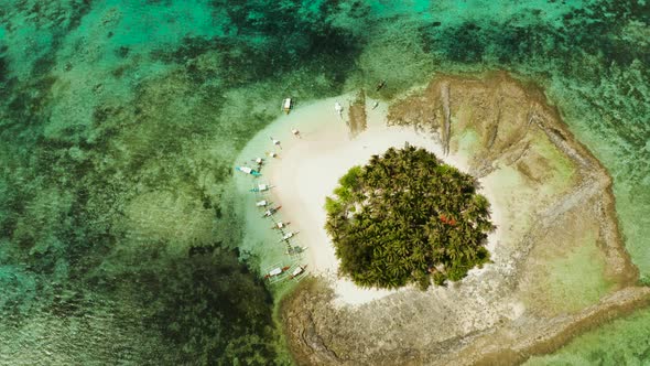 Tropical Guyam Island with a Sandy Beach and Tourists