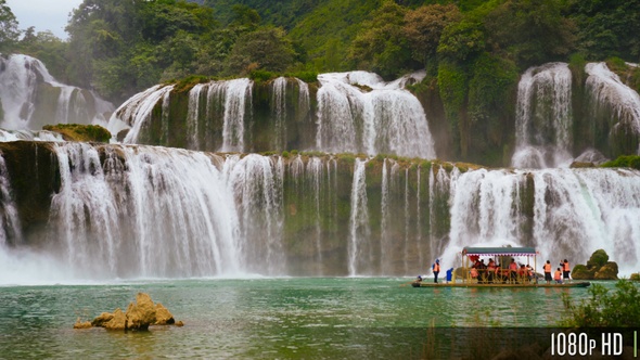 Panoramic Ban Gioc Waterfall In Vietnam With Boat of Tourists