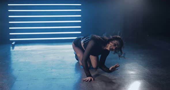Attractive Woman Sexually Dancing on the Floor in the Lower Pit