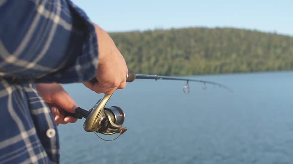 Fisherman Standing on Riverside and Trying To Catch Fish