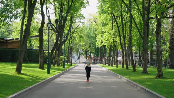 Woman with Curvy Forms Jogging in Park