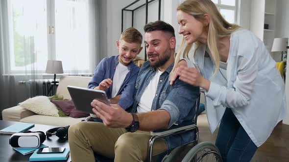 Mother, Son and Bearded Father in Wheelchair which Having Video Call