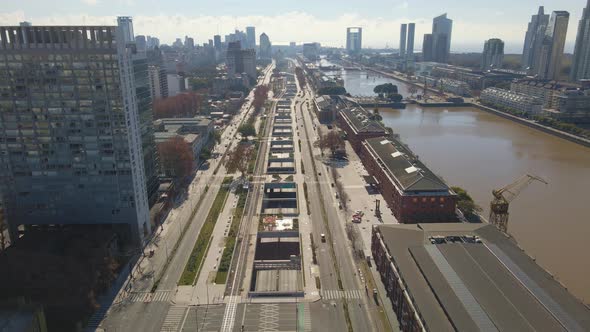 Aerial flying over Paseo del Bajo highway in Buenos Aires's Puerto Madero neighborhood with some tra