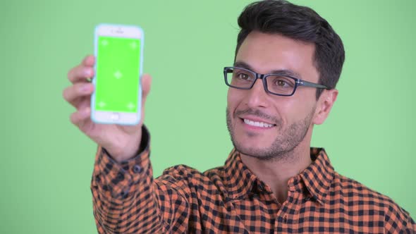 Face of Happy Young Hispanic Hipster Man Showing Phone