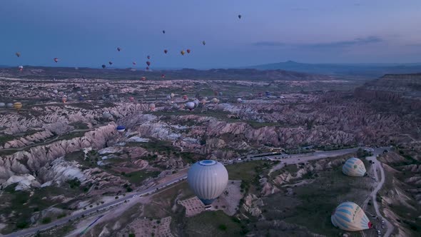 4K Aerial view of Goreme. Colorful hot air balloons fly over the valleys.