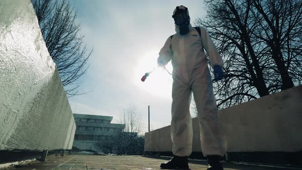 Sanitation Worker is Spraying Chemicals Outside