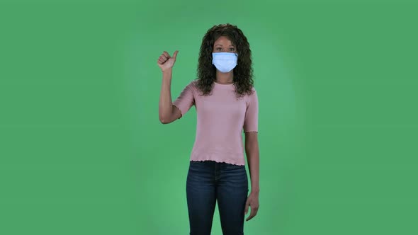 Portrait of Beautiful African American Young Woman in Medical Protective Face Mask Is Looking at