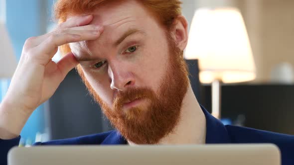 Tired Man working on Laptop, Close Up