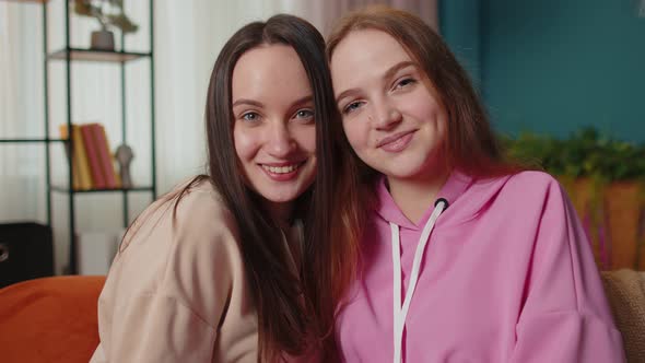 Close Up Portrait of Happy Attractive Girls Friends Siblings Embracing Smiling Looking at Camera