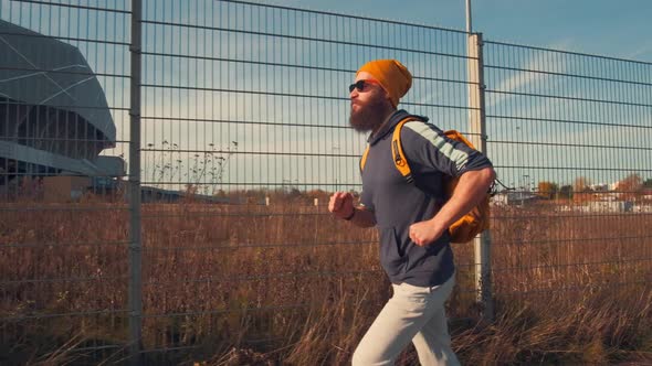 Hipster Sports Man Jogging in City. Urban Active Life