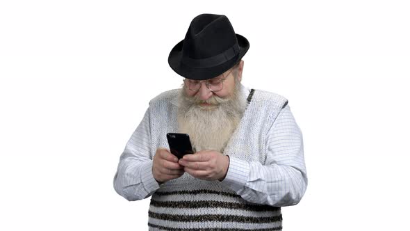 Retired Man with Beard Using Mobile Phone