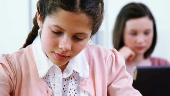 Schoolgirl working on electronic project in classroom