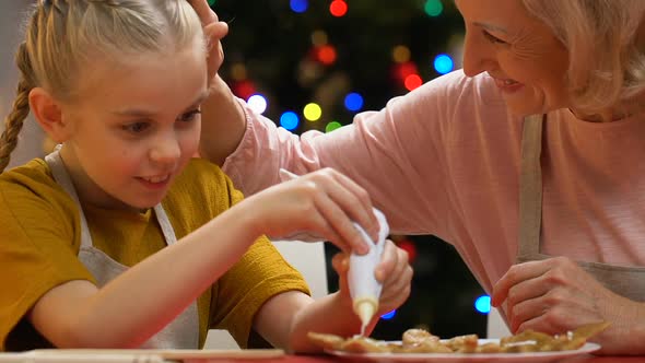 Little Girl Decorating Gingerbread With Icing Sugar