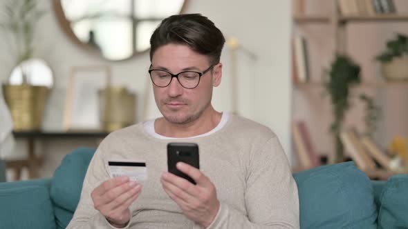 Online Shopping on Smartphone By Middle Aged Man