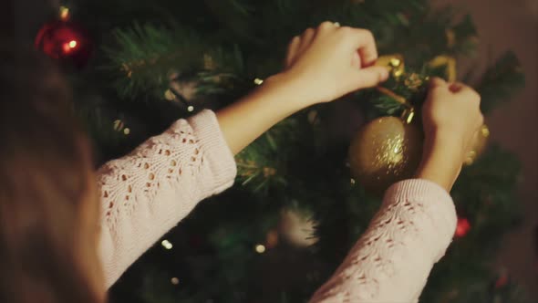 Girl Hands Decorate Christmas Tree Close Up