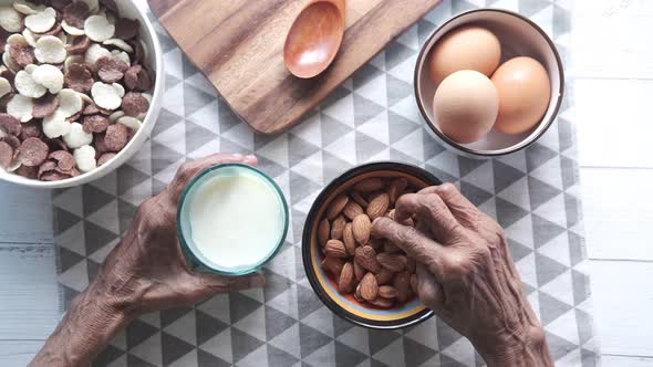 Close Up Senior Women Hand Holding a Bowl on Almond