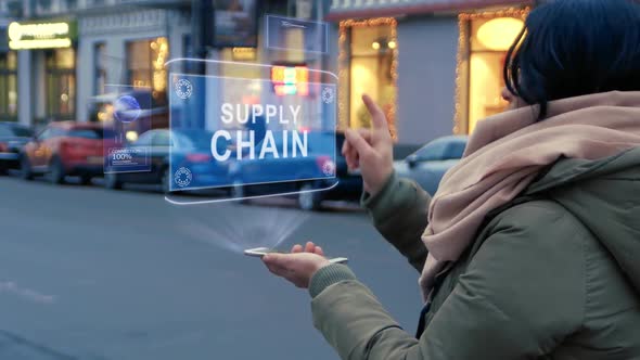 Unrecognizable Woman Standing on the Street Interacts HUD Hologram with Text Supply Chain