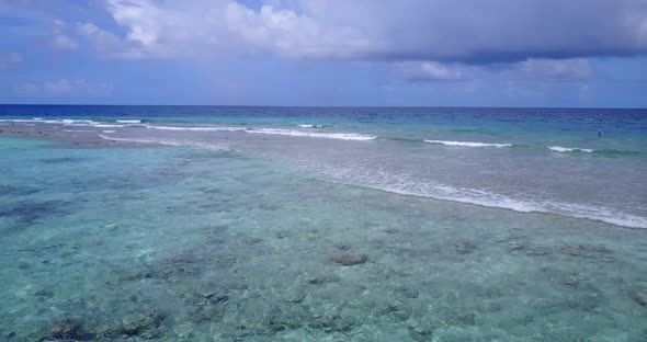 Beautiful above island view of a paradise sunny white sand beach and blue sea background in vibrant 