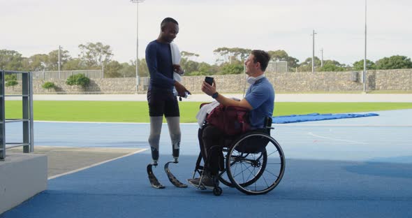 Two disabled athletics discussing over mobile phone 4k