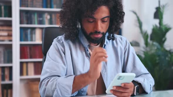 Young Arabian Man Student Gets Nervous Typing Message or Passing Exam on Phone