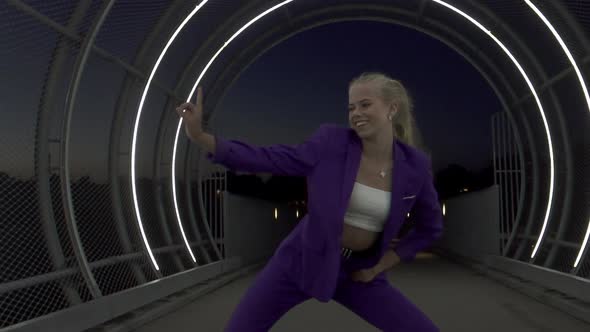 Blonde Female Performer Passionately Dancing in an Open Tunnel