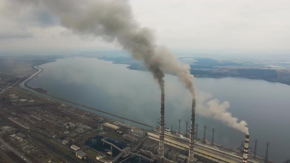 Aerial View of Coal Power Plant High Pipes with Black Smoke Moving Up Polluting Atmosphere