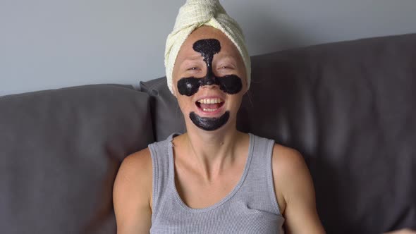 Handheld Type of Shot of Beautiful Young Woman with a Black Face Mask