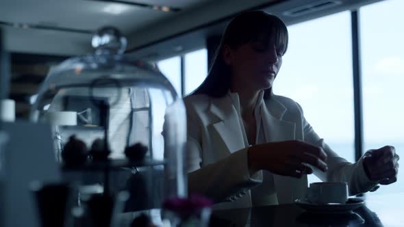 Stressed Woman Suffering Alone at Sea View Cafe