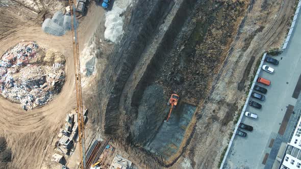 Aerial View on Top Excavator That Digs and Levels the Pit for the House