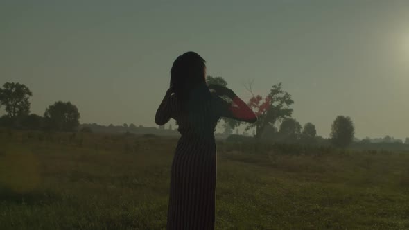 African Female with Arms Outstretched Enjoying Peace and Serenity in Nature